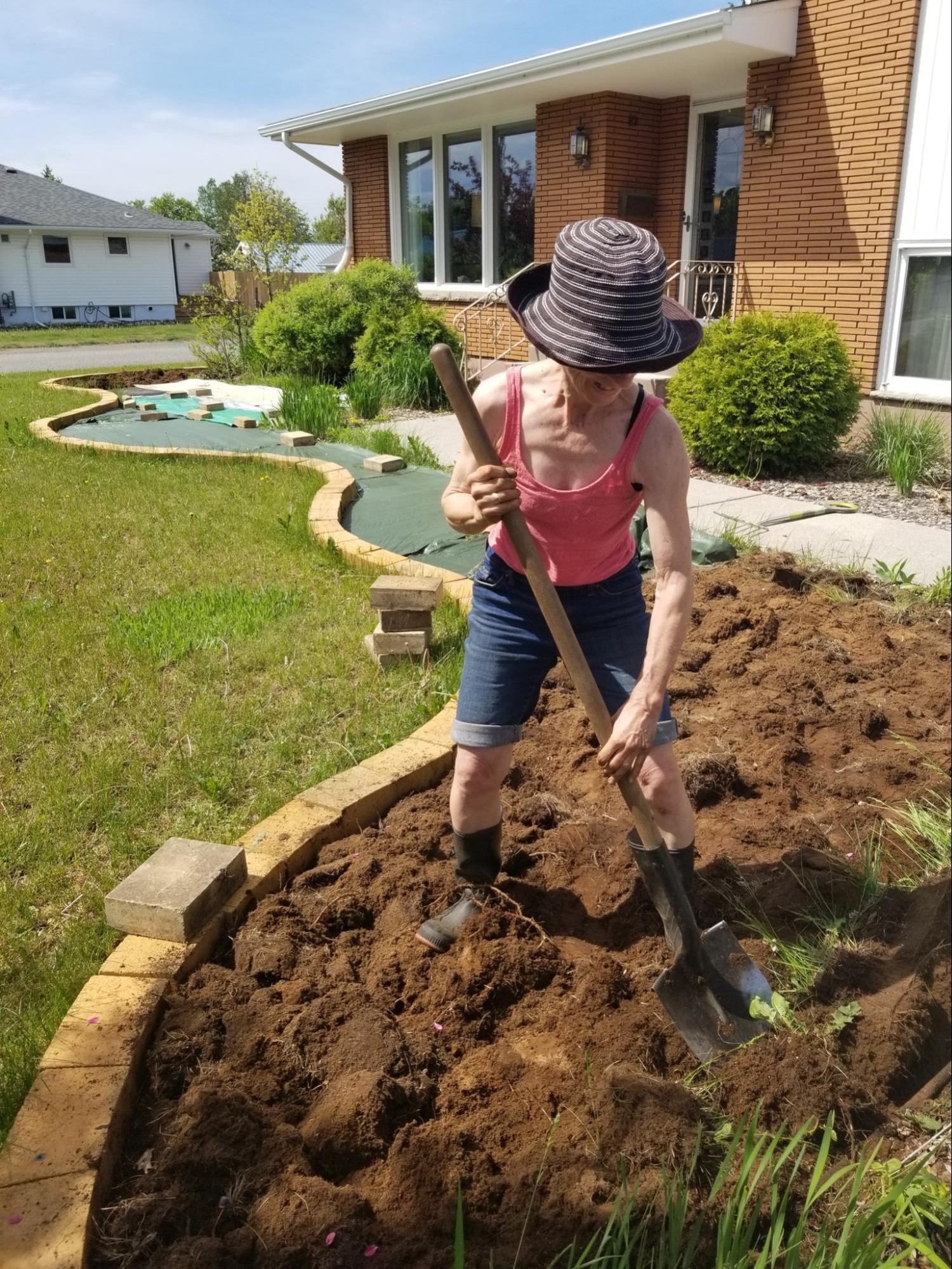 gardener digging in butterfly garden